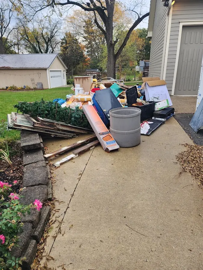 Dumpster being loaded with debris for Commercial Dumpster Rental in Concord